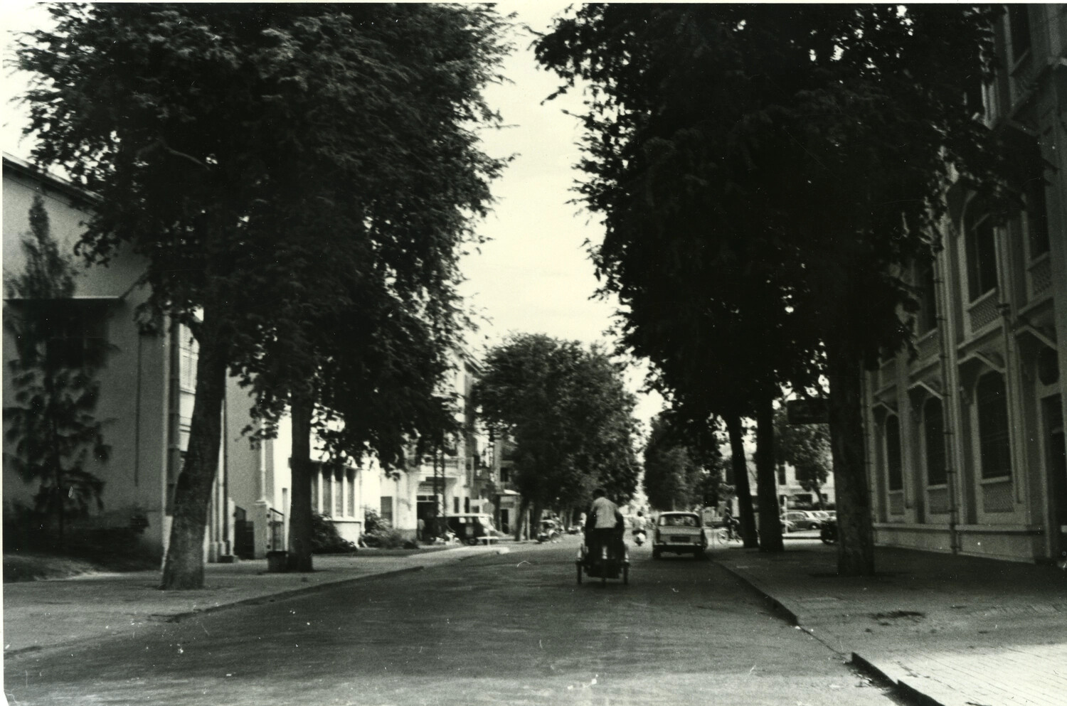 Tree-Shaded Residential Street with Cyclo and Parked Car, Phnom Penh, Cambodia, c. 1960s