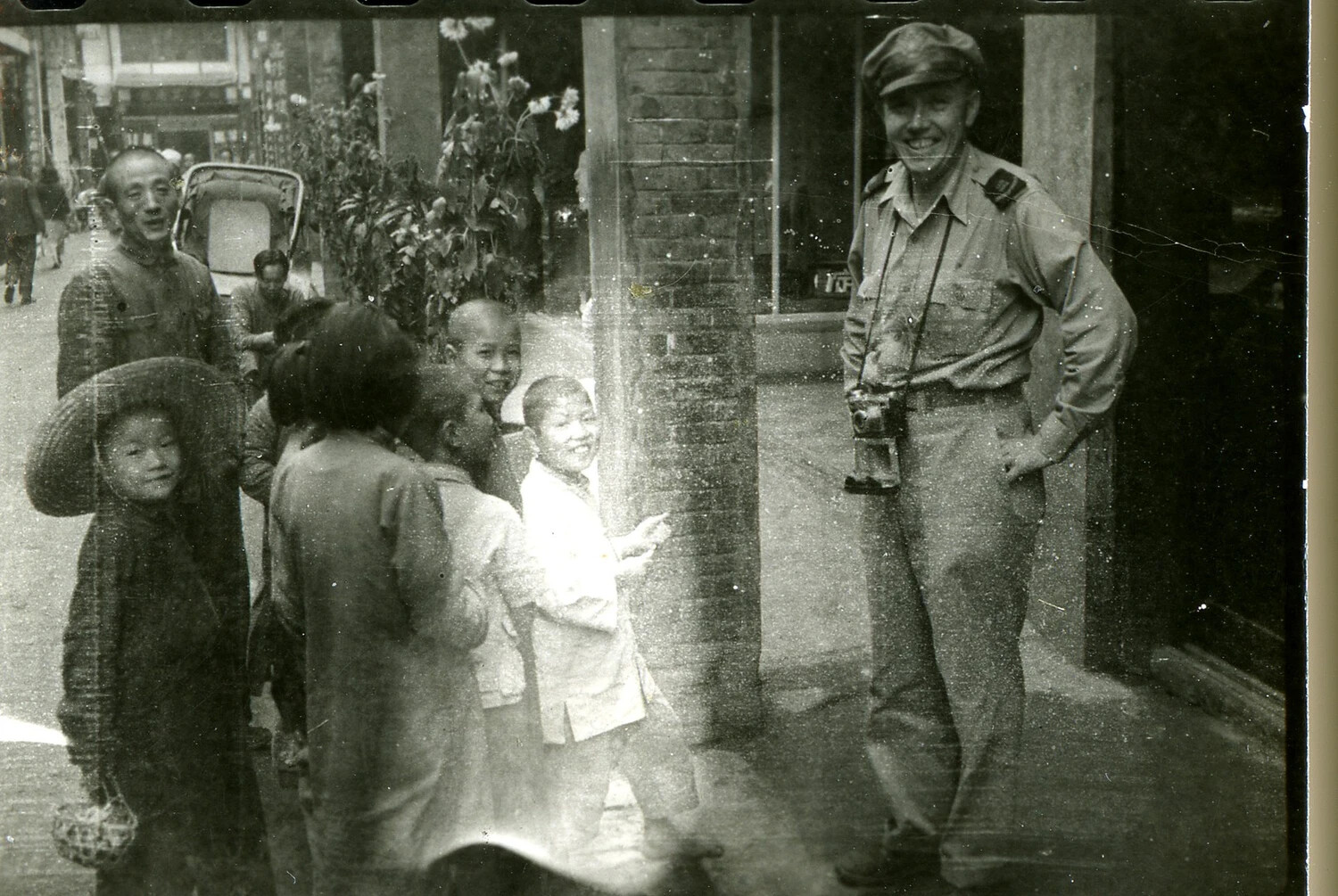 American Serviceman with Local Chinese Children on a City Street, CBI Theater, WWII
