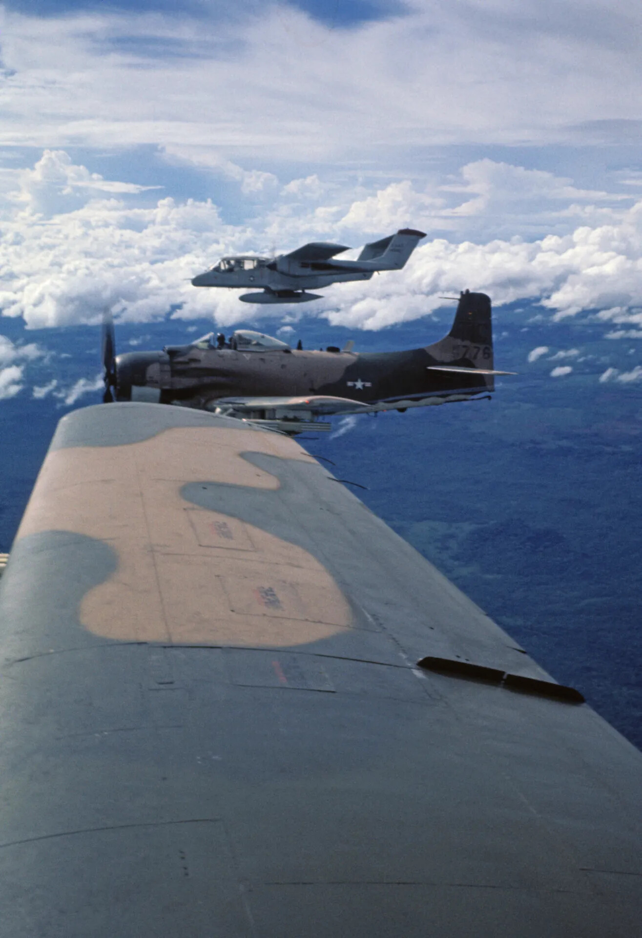 A-1 Skyraider and OV-10 Bronco in Formation over Southeast Asia, Vietnam War (Standard Resolution)