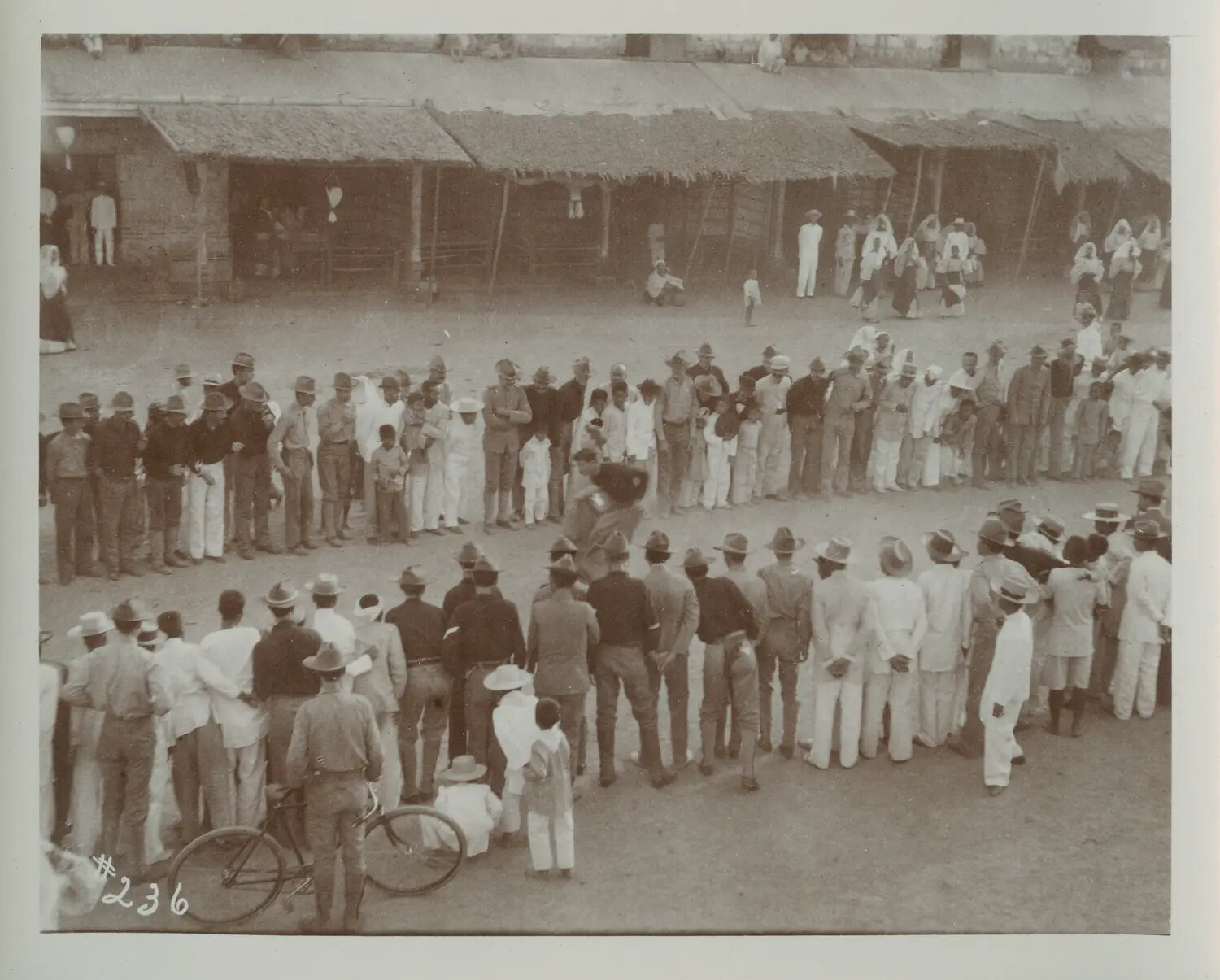 American Soldiers and Filipino Civilians Gathered in Formation, Philippine Village, Turn of the 20th Century