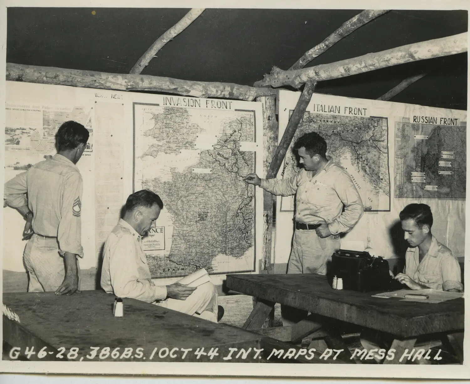 386th Bomb Squadron Personnel Reviewing Theater Situation Maps at Mess Hall, 10 October 1944