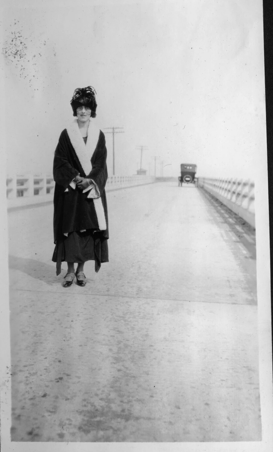 Woman in Fur-Trimmed Coat and Feathered Hat on a Roadway Bridge, Presidio Album, c. 1920-1925