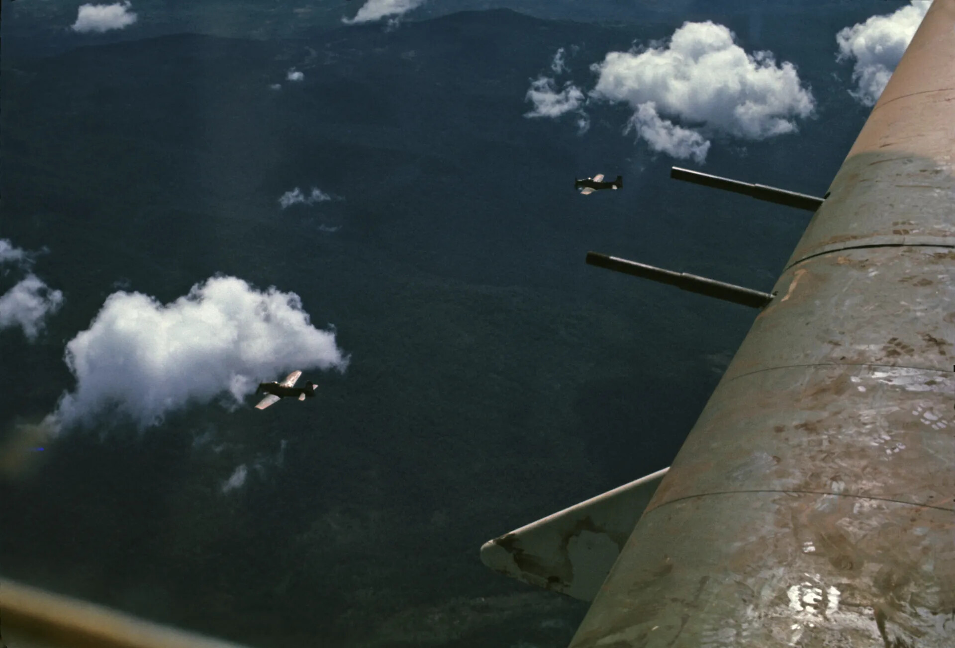In-Flight View of Formation Aircraft over Jungle Terrain, Vietnam War Era