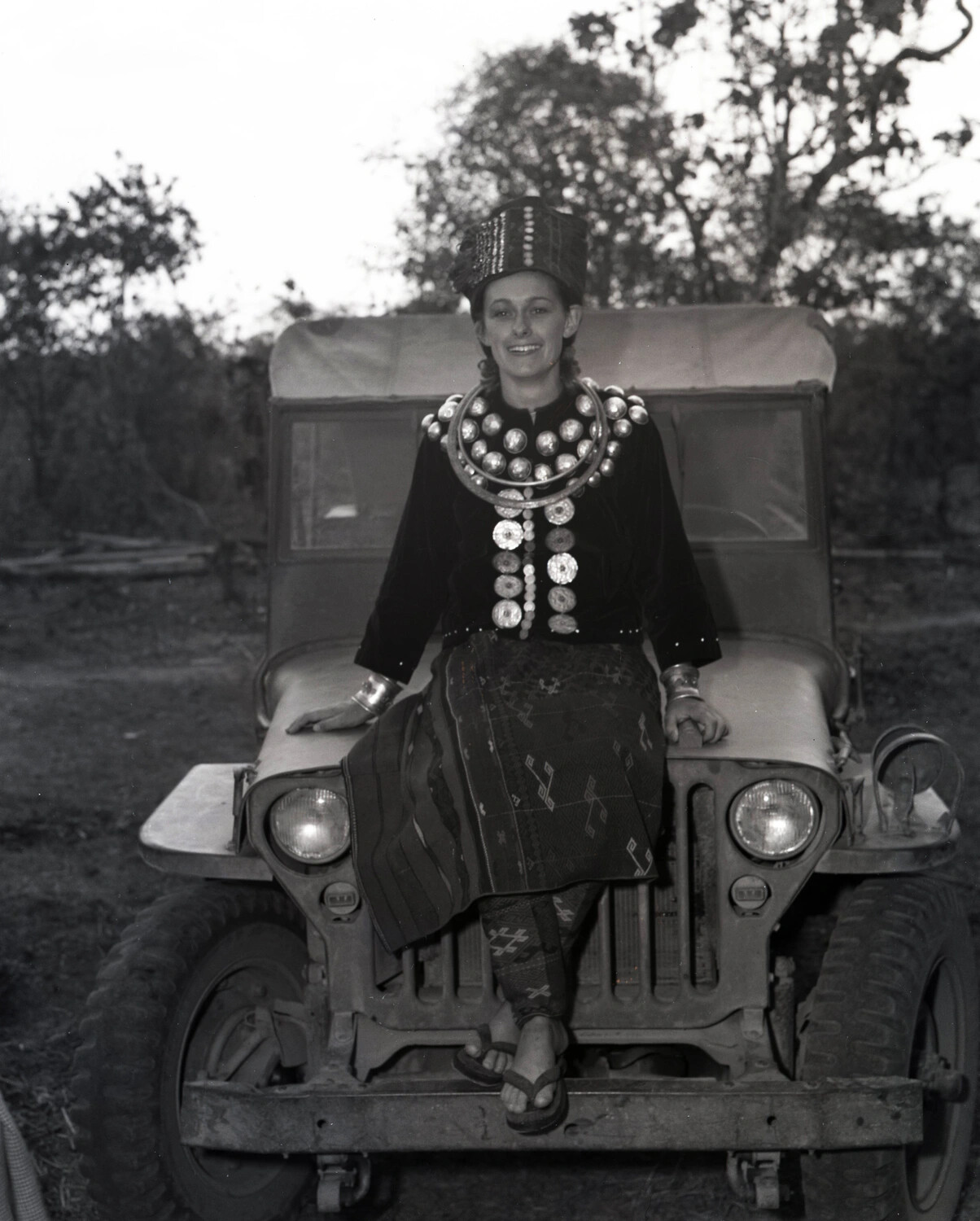 Young Woman in Traditional Karen/Burmese Ceremonial Dress Seated on US Army Jeep, CBI Theater, WWII