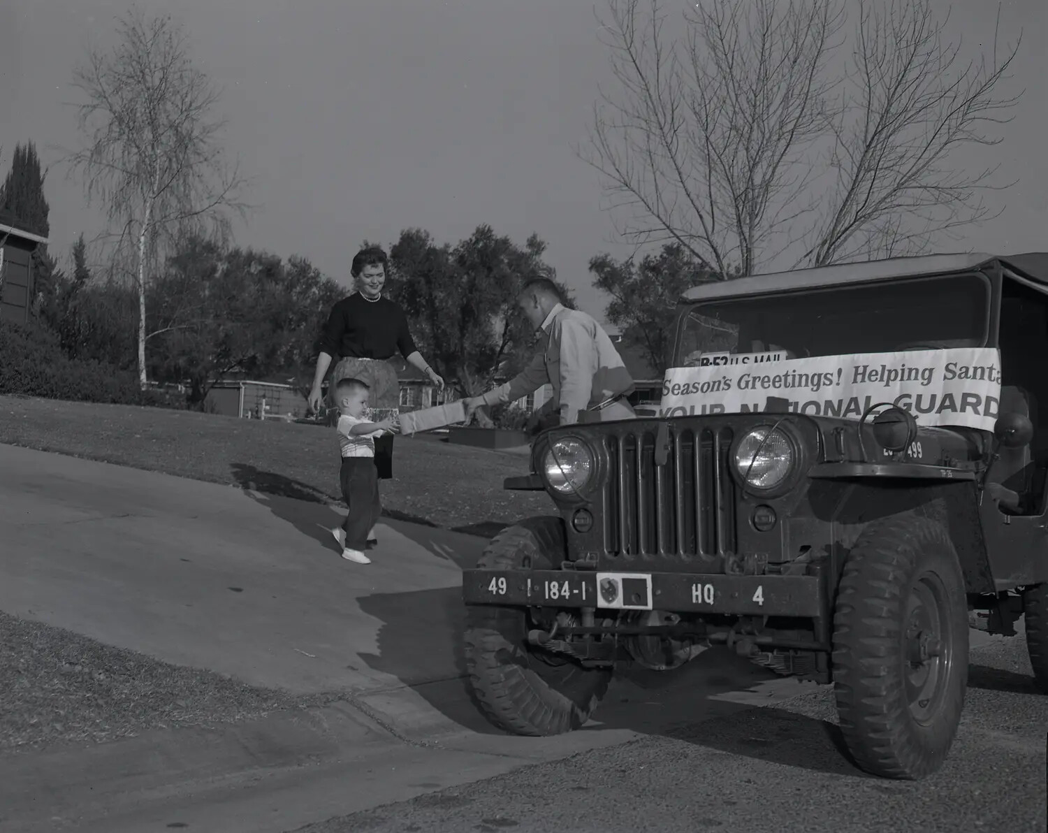 National Guard M38A1 Jeep Christmas Toy Delivery, Suburban Residence, c. late 1950s (Frame 3)