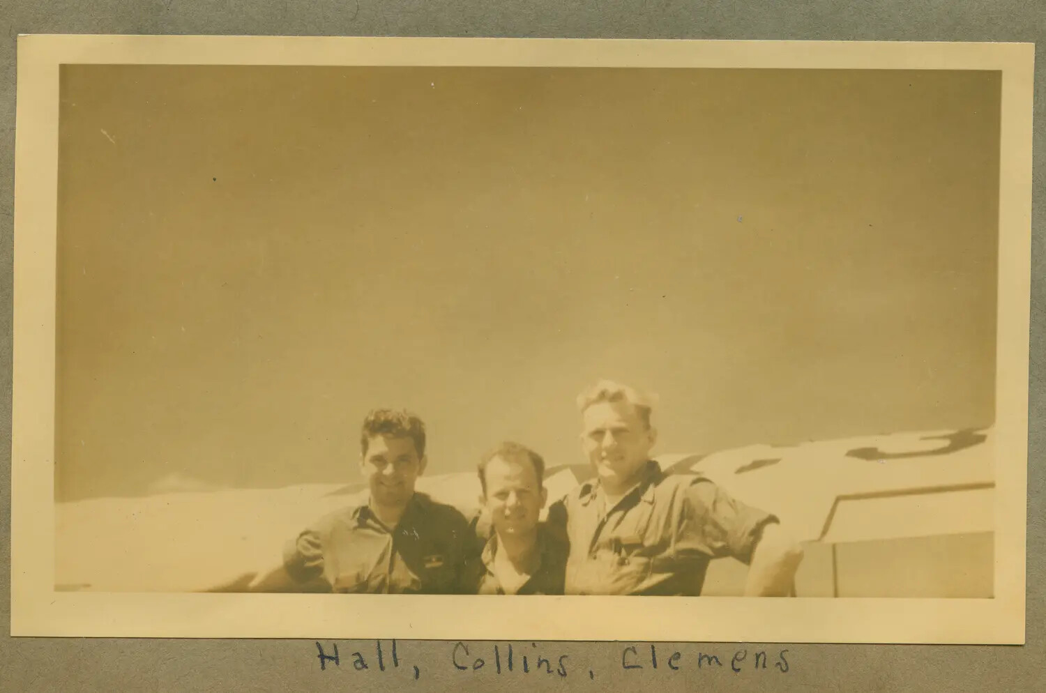 Group Portrait of Hall, Collins, and Clemens Beside a Training Aircraft