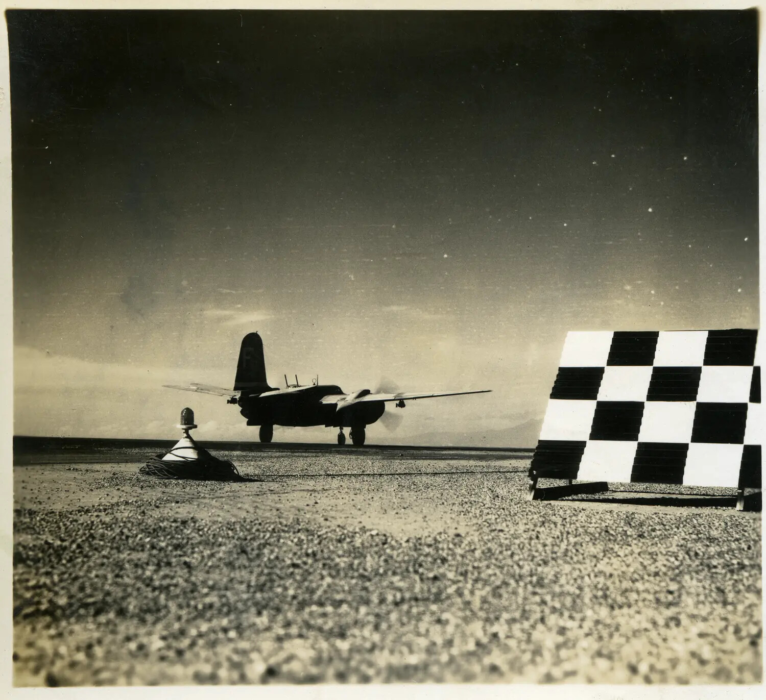 Twin-Engine Light Bomber on Airfield at Dusk with Checkerboard Ground Panel, 312th Bomb Group