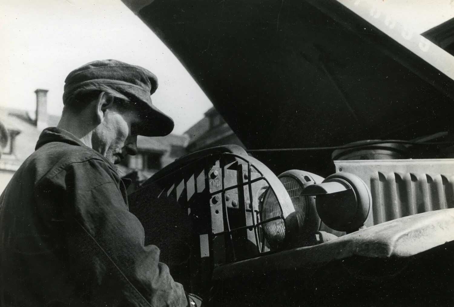 Mechanic Examining Truck Headlamp and Convoy Light, Close Detail View