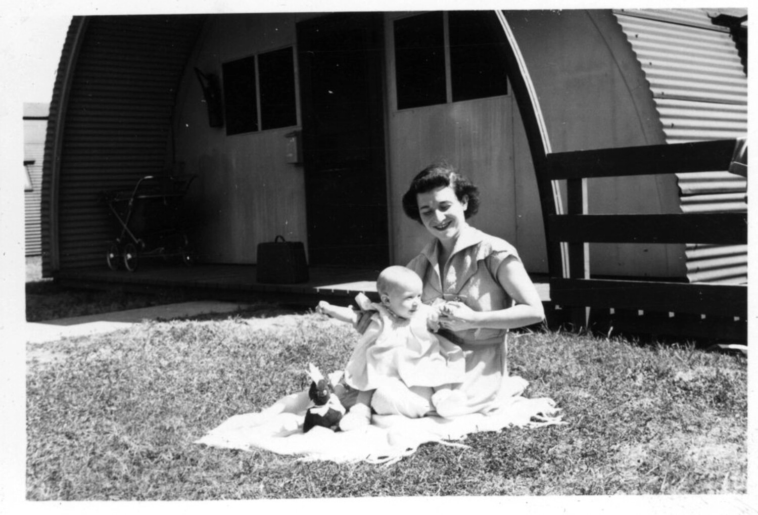 Navy Officer's Wife and Infant Outside Quonset Hut Family Quarters, Korean War Era