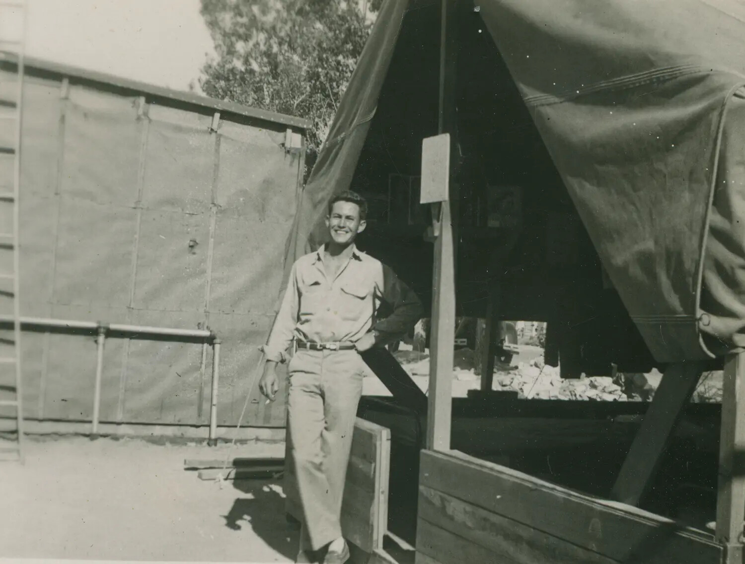 Serviceman Posing at Camp Tent Structure - Pat McAleer Collection