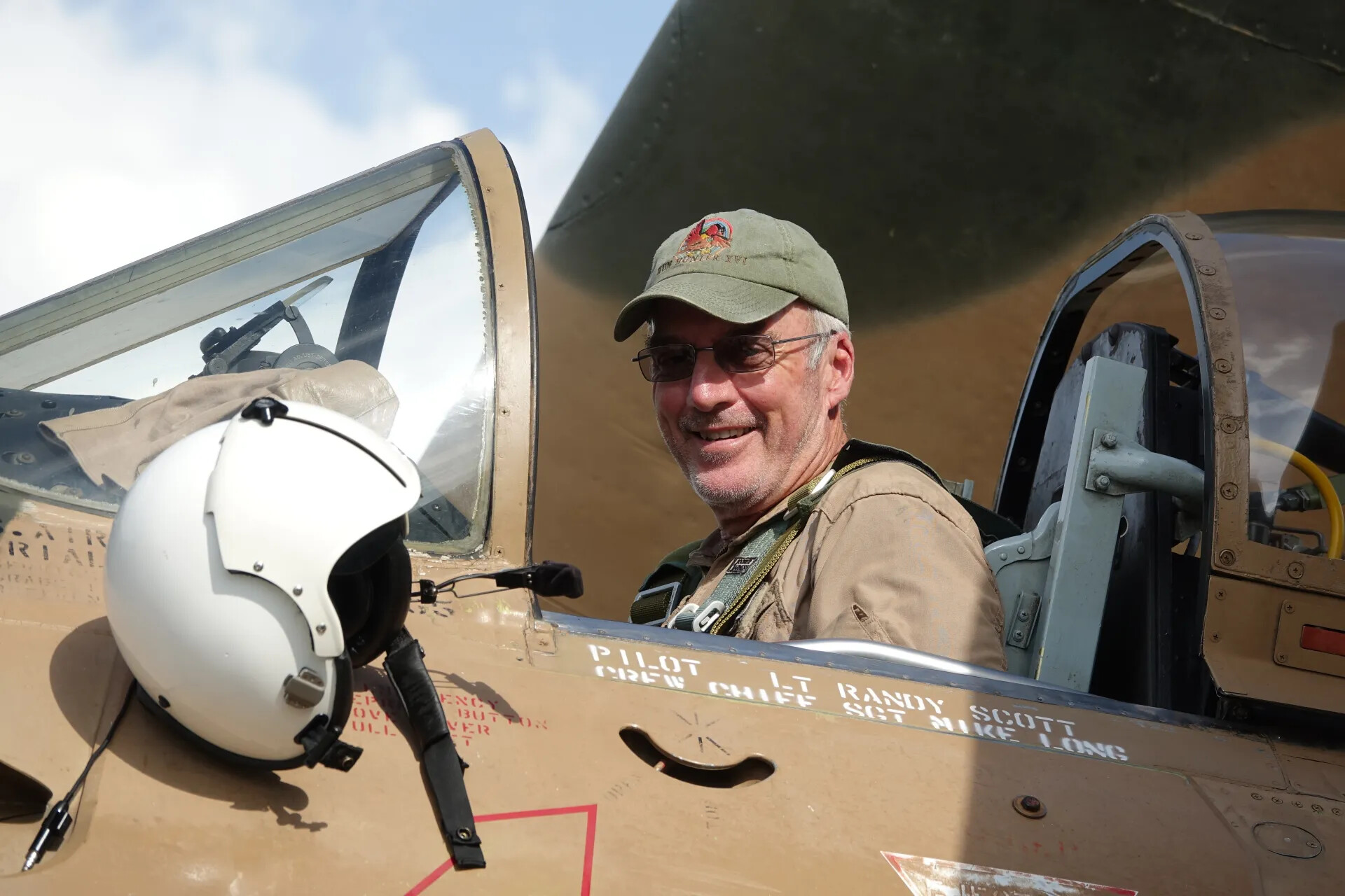 Man in Cockpit of Camouflaged Warbird Marked 'PILOT LT RANDY SCOTT,' May 2019 Event