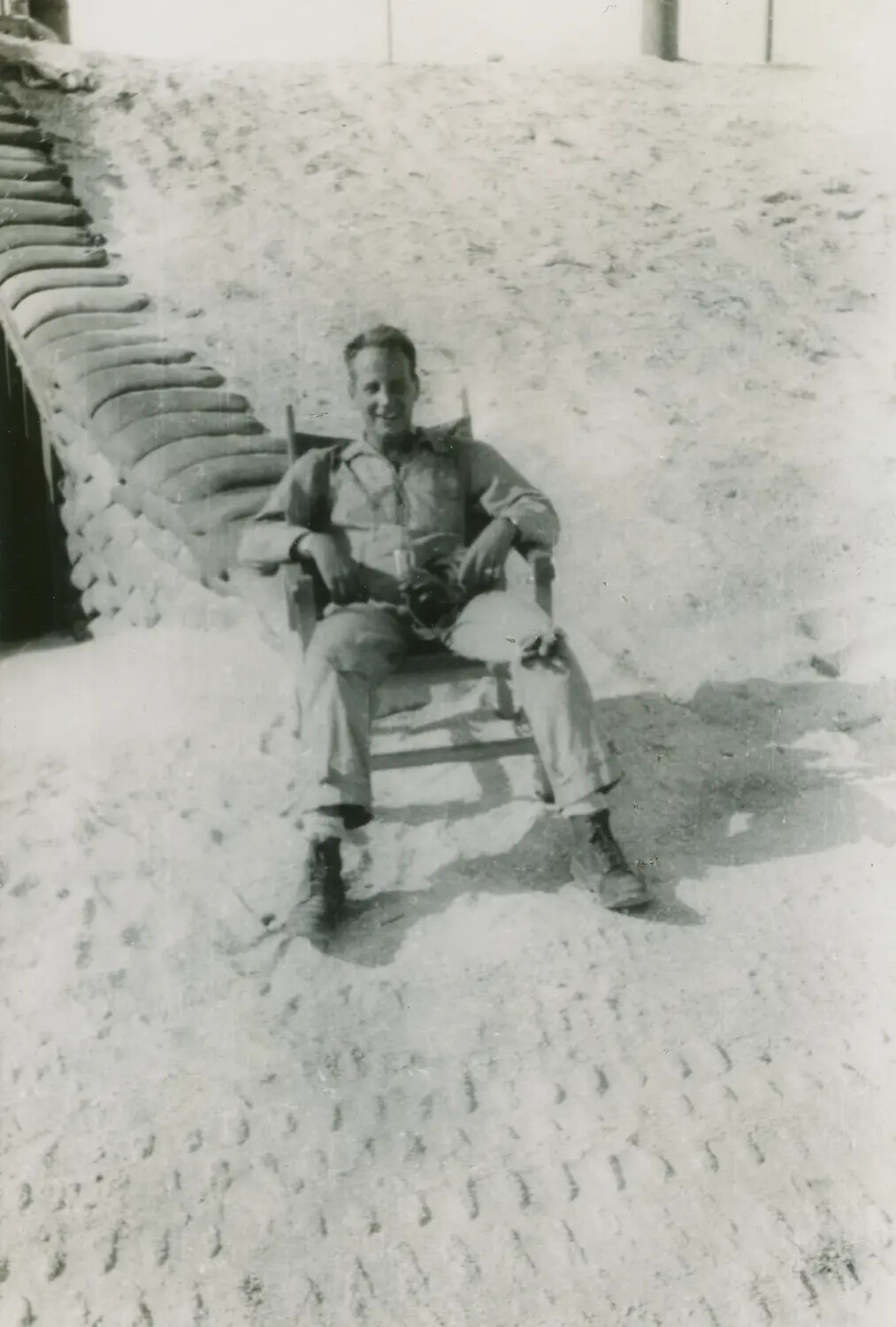 Serviceman Seated at Improvised Steel-Matting Revetment, Edward P. McAleer Photo Album, WWII