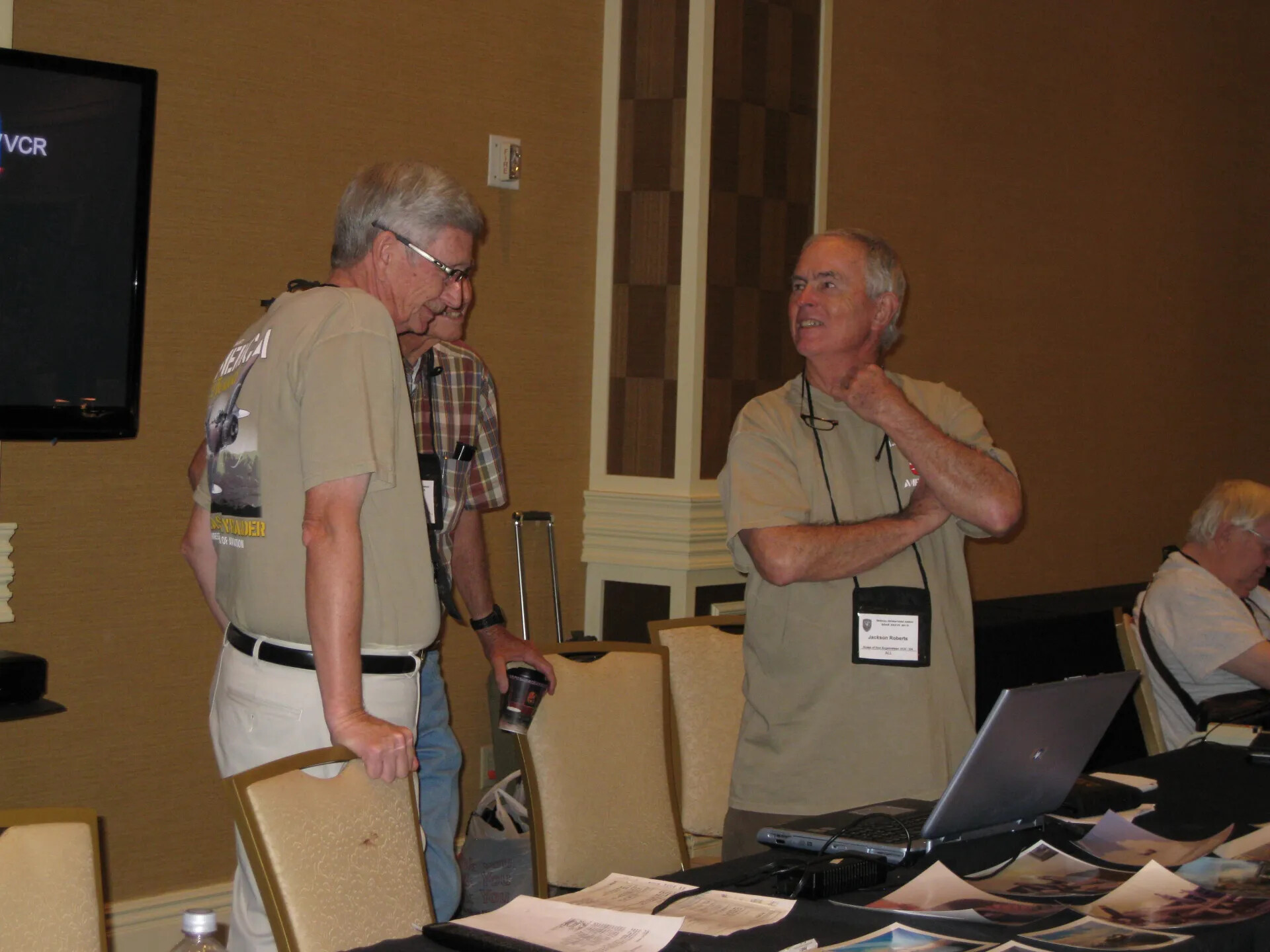 Jackson Roberts in Conversation Beside a Photograph and Laptop Display Table, SOAR XXXVII, Las Vegas, 2013