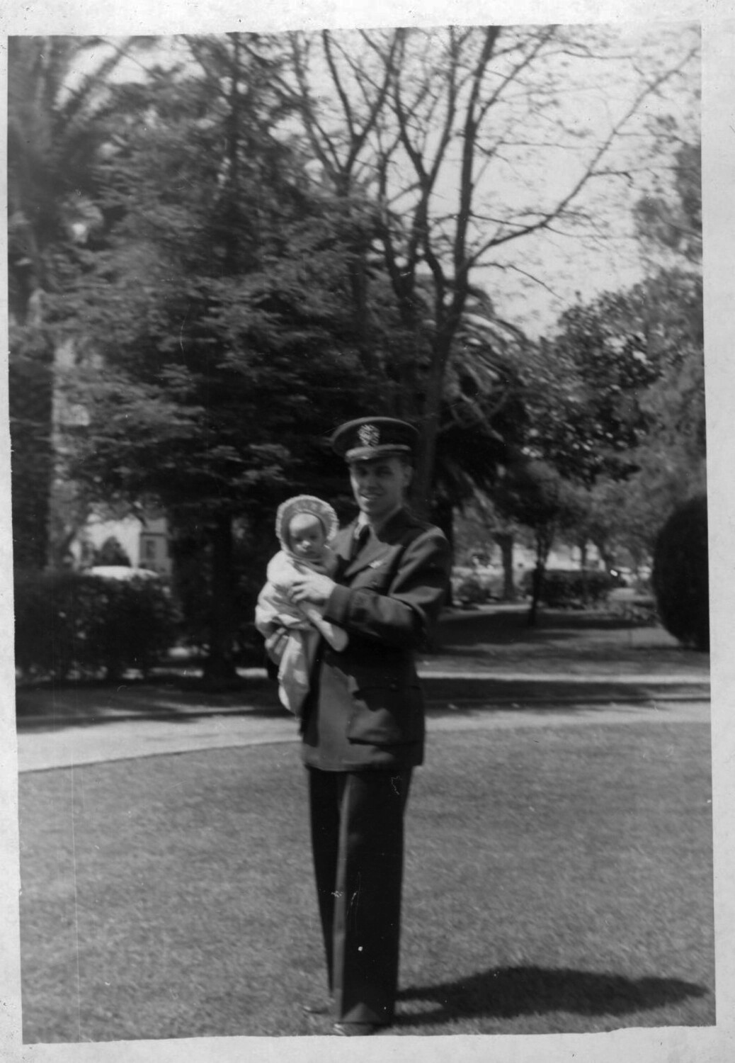 Naval Officer Holding Infant in Park Setting - Lt. Bancroft Korean War Collection
