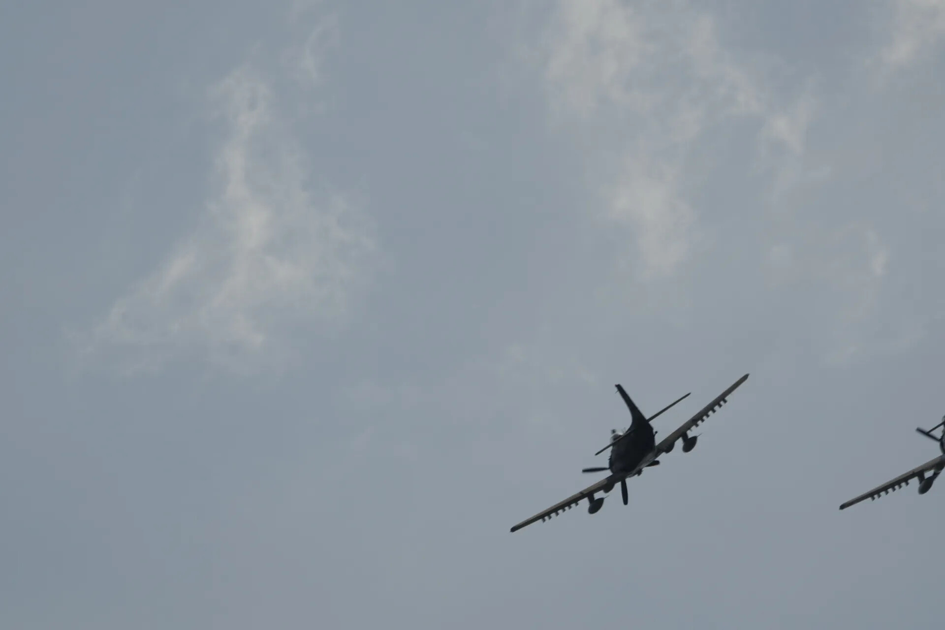 Two A-1 Skyraiders in Banked Turn, Silhouette Against Overcast Sky, May 2019 Airshow