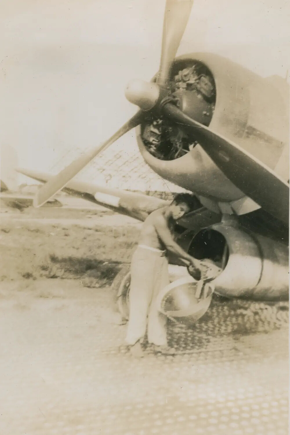 Serviceman Servicing Radial Engine of Single-Engine Aircraft on Marston Mat Airfield, WWII Era (McAleer Collection)
