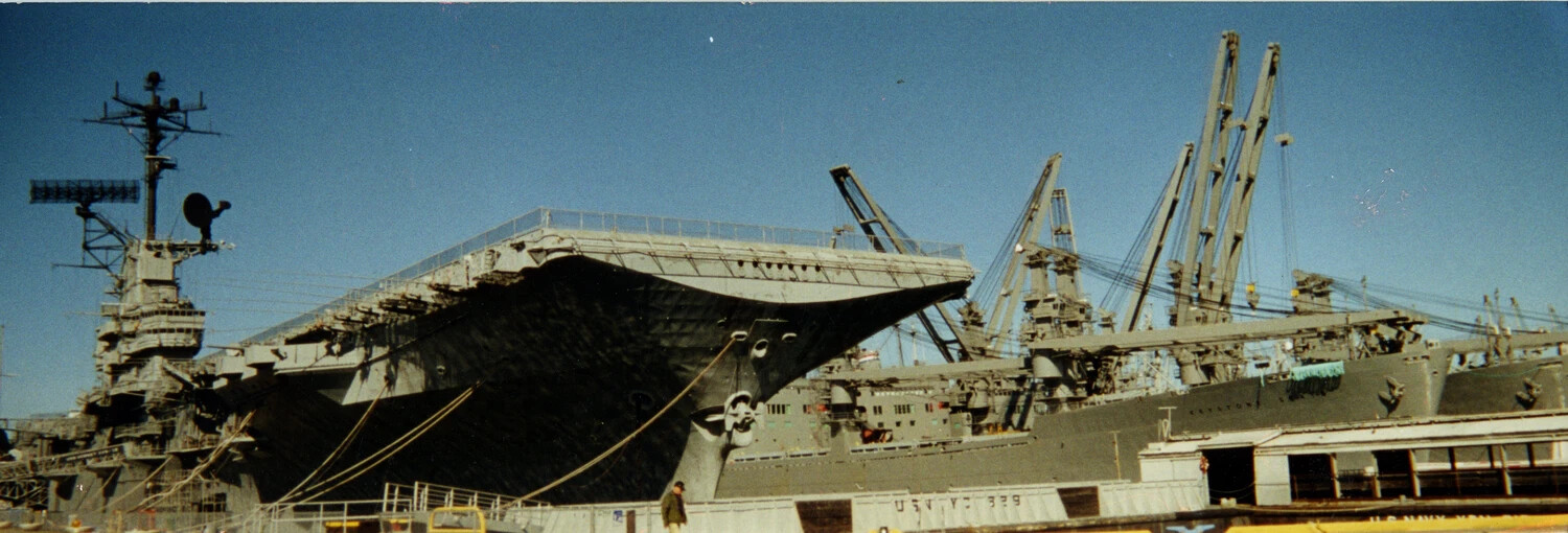 Essex-Class Aircraft Carrier (likely USS Ticonderoga) in Shipyard Overhaul, Vietnam War Era