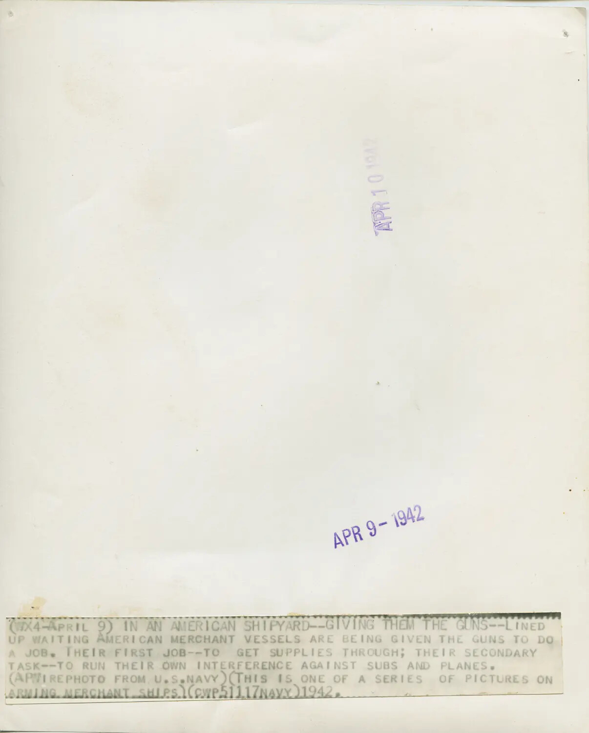 Verso of WWII AP Wirephoto with Caption: 'In An American Shipyard--Giving Them The Guns' (Arming Merchant Ships Series), April 1942