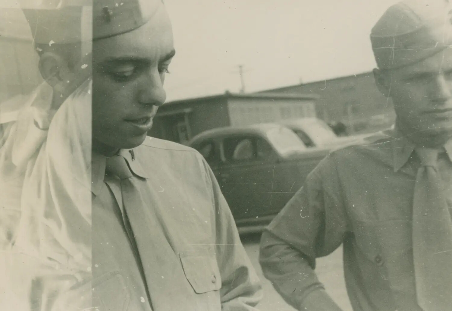 Double-Exposed Snapshot of Two Servicemen in Uniform at a Military Post