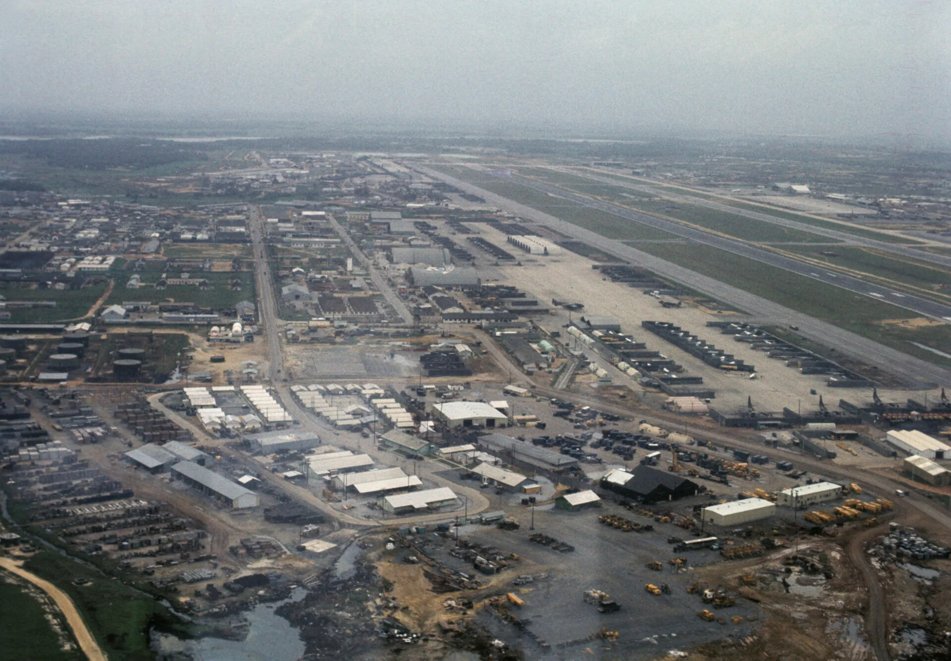 Aerial View of Military Airbase with Runway and Support Facilities