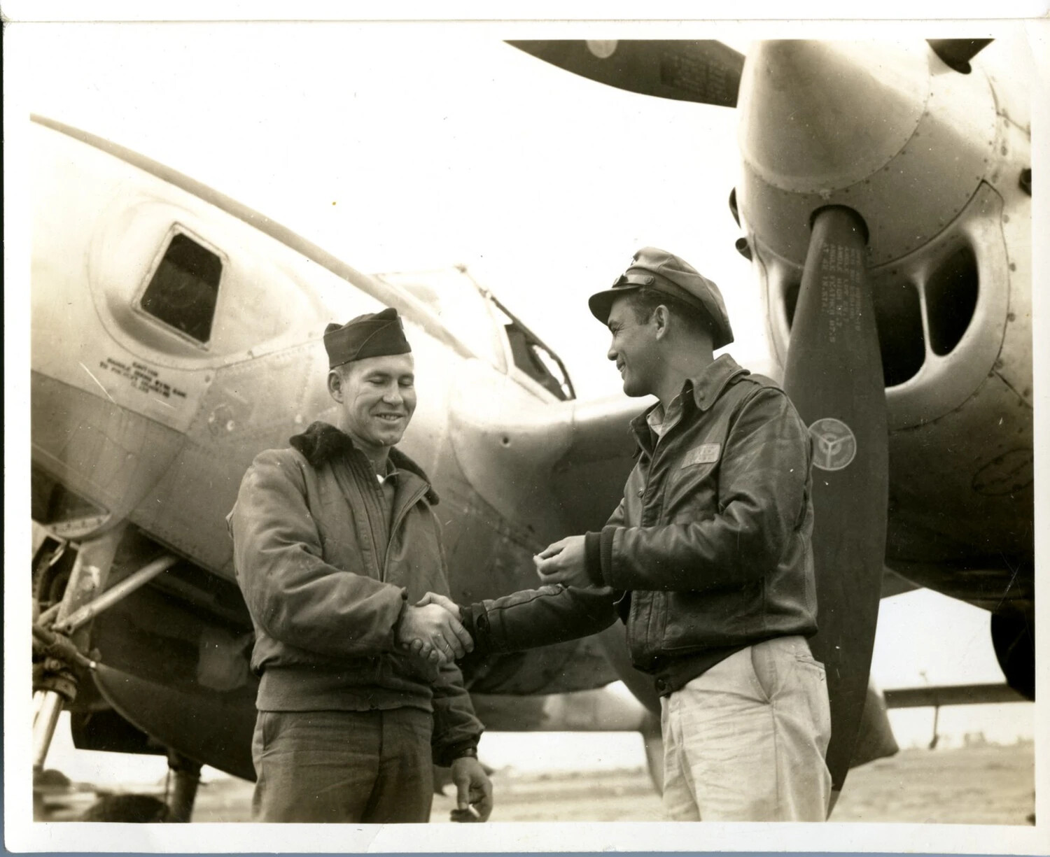 Two Airmen Shaking Hands Beside Lockheed P-38 Lightning, World War II