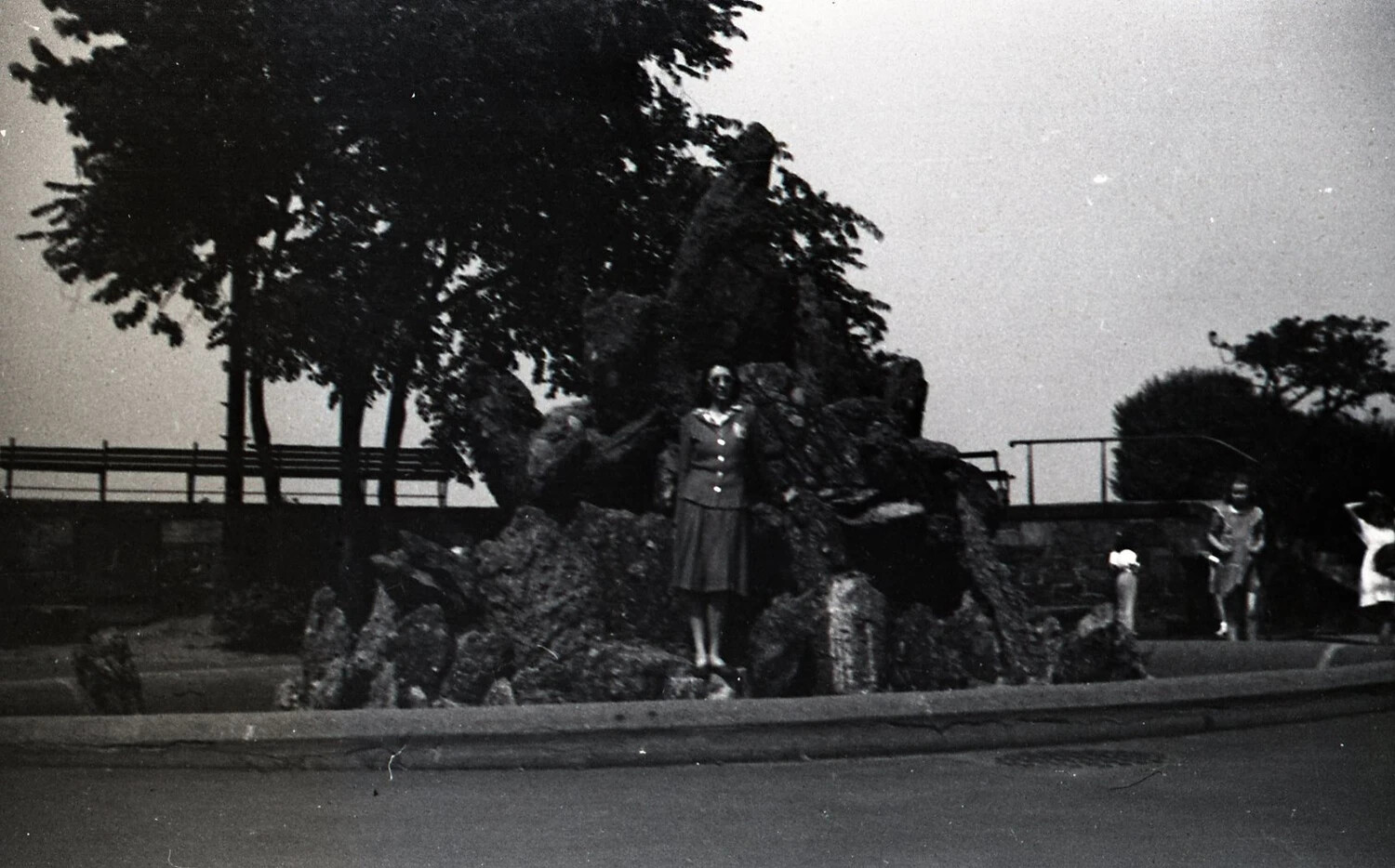 Woman in Uniform Dress at an Urban Park Rock Garden, Dusk, c. 1940s
