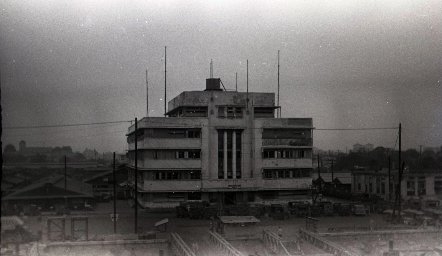 War-Damaged Art Deco Building with U.S. Military Vehicles, Manila, Philippines, WWII