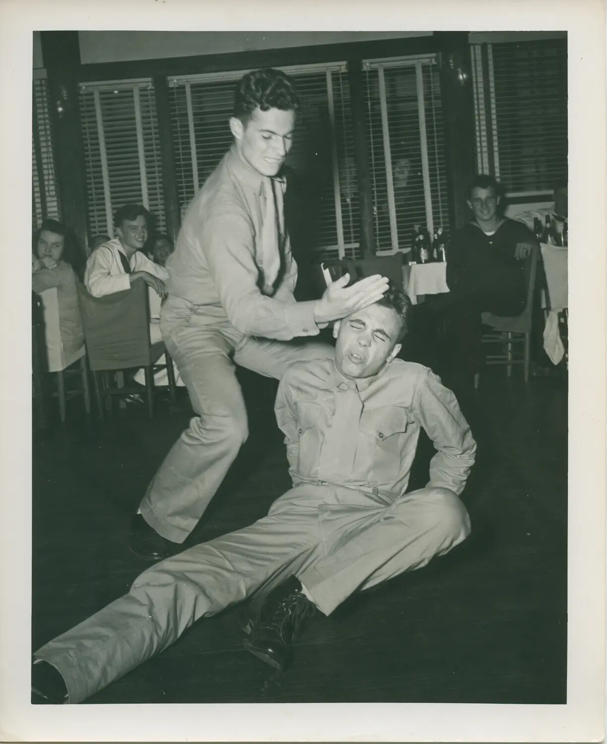 Sailors Horsing Around at an Indoor Social Gathering, USS Petrof Bay (CVE-80) Collection
