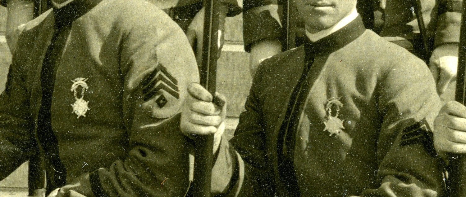 Detail View: NCO Chevrons and Marksmanship Badges, Rifle Team Cabinet Photograph (Early 20th Century)