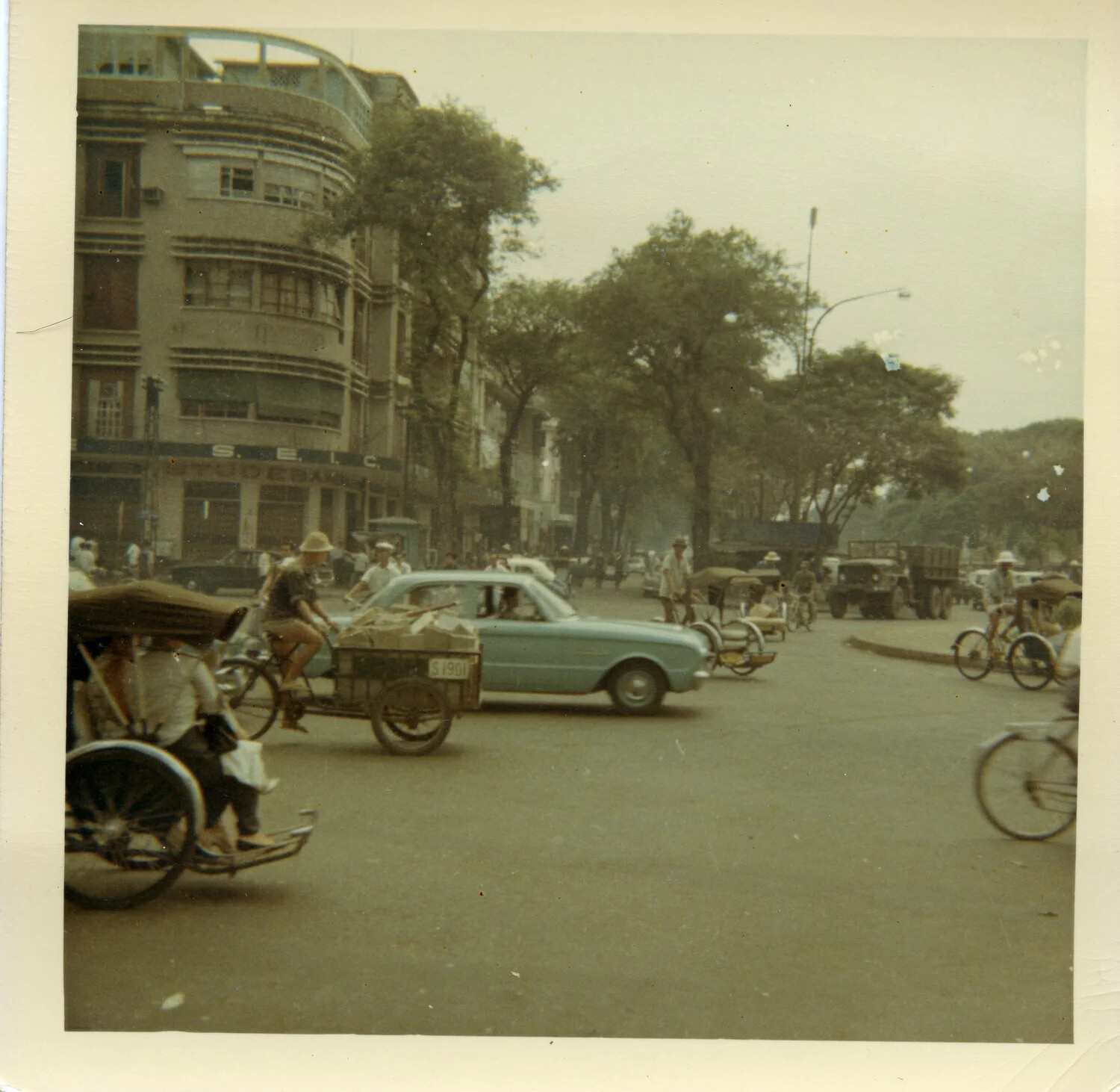 Street Scene in Saigon with Cyclos, Automobiles, and Military Trucks, South Vietnam, 1964