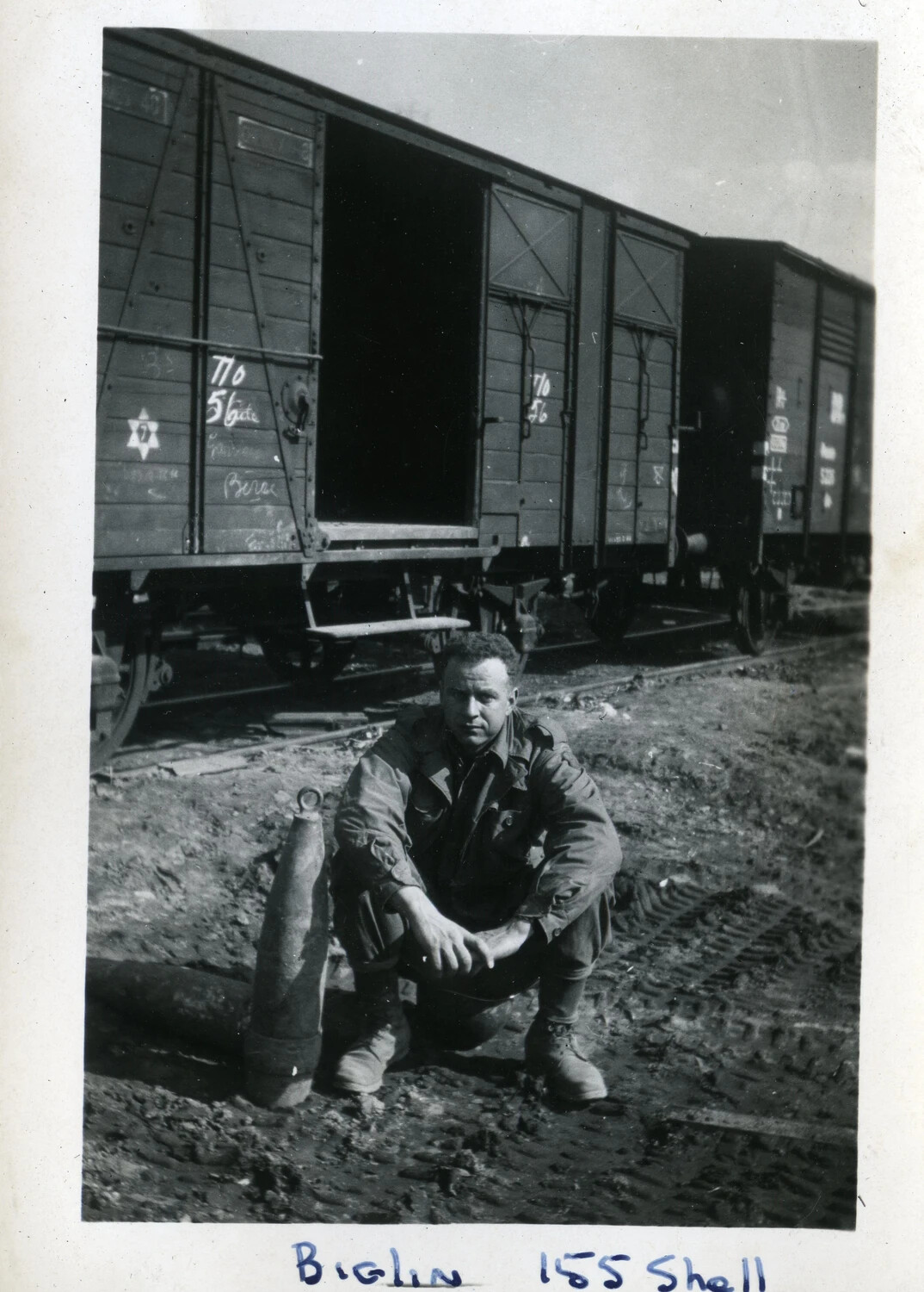 U.S. Soldier ('Biglin') with 155mm Artillery Shell Beside Rail Boxcars, WWII European Theater