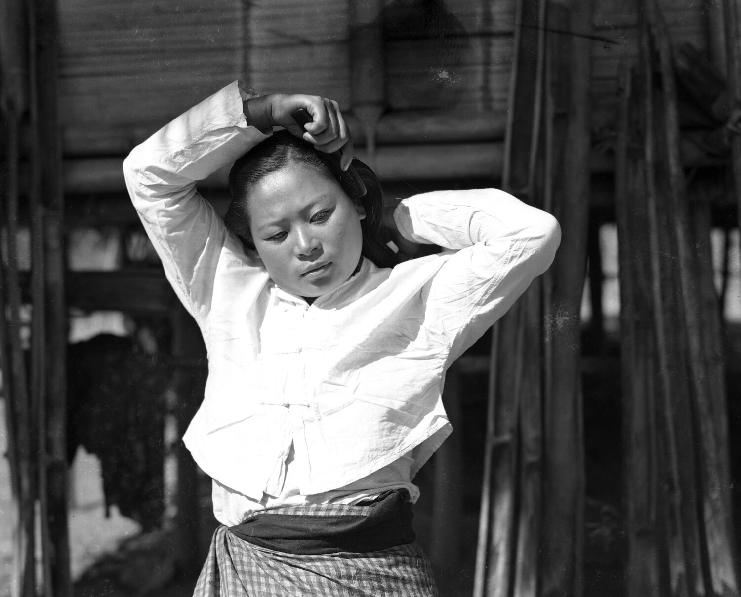 Young Woman Arranging Her Hair, China-Burma Village Setting, WWII Era