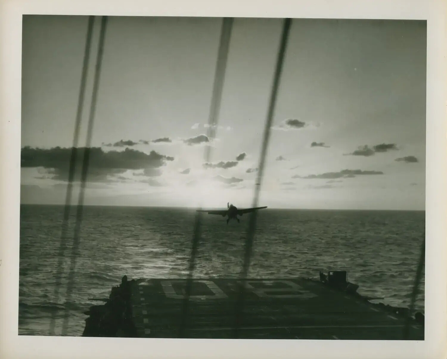 Carrier Aircraft on Final Approach at Dawn/Dusk, USS Petrof Bay (CVE-80)