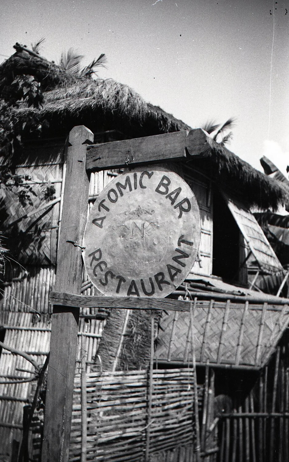 "Atomic Bar Restaurant" Sign at a Nipa Hut, Luzon, Philippines, WWII Era