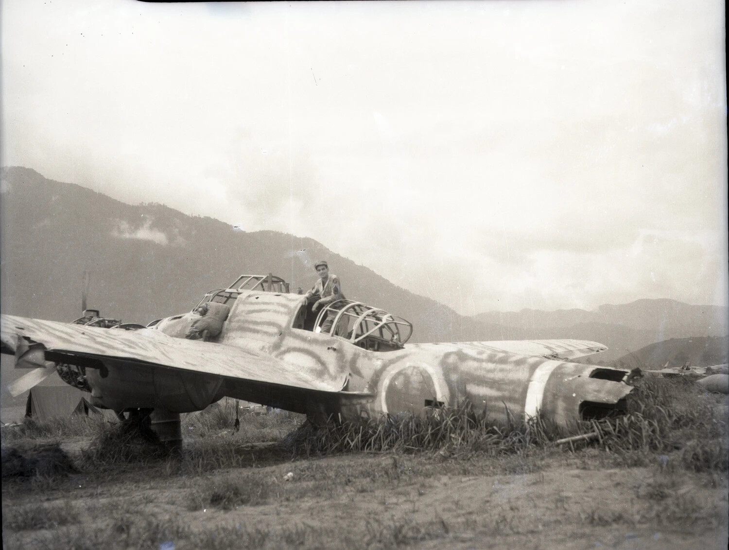 Derelict Twin-Engine Japanese Aircraft Examined by American Servicemen, Okinawa/Ie Shima Campaign, 1945