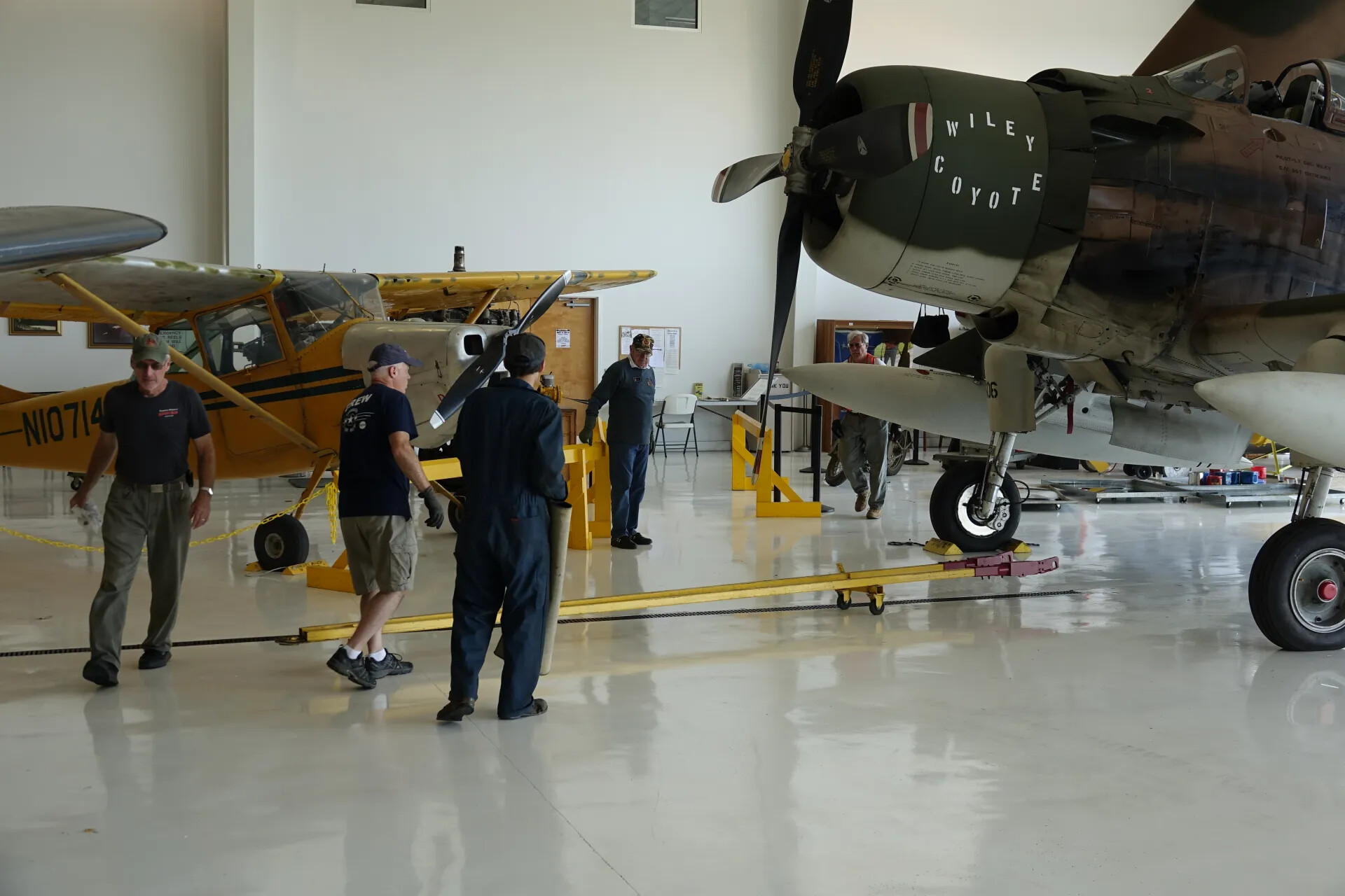 Museum Volunteers Preparing Aircraft in Hangar, A-1 Skyraider 'Wiley Coyote' and Vintage Taildragger