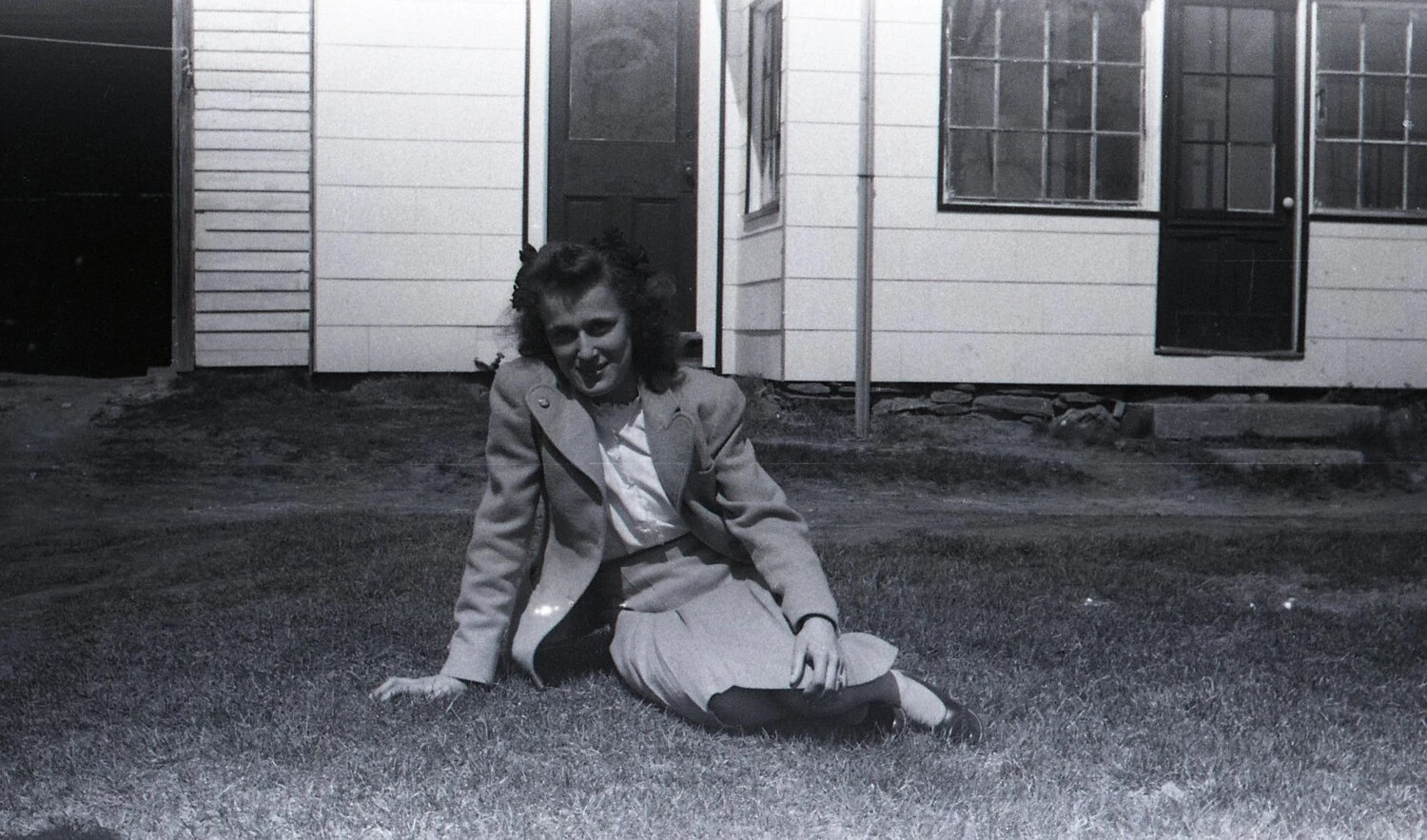 Young Woman Seated on Lawn Before Farmhouse, State-Side, WWII Era