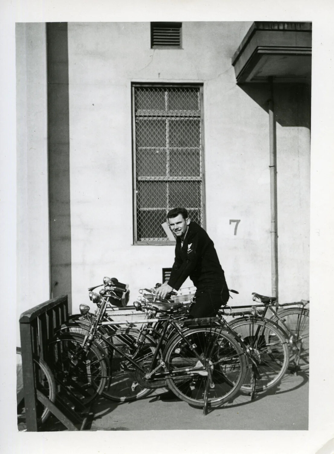 U.S. Navy Petty Officer with Bicycles Outside Building No. 7, Korean War Era