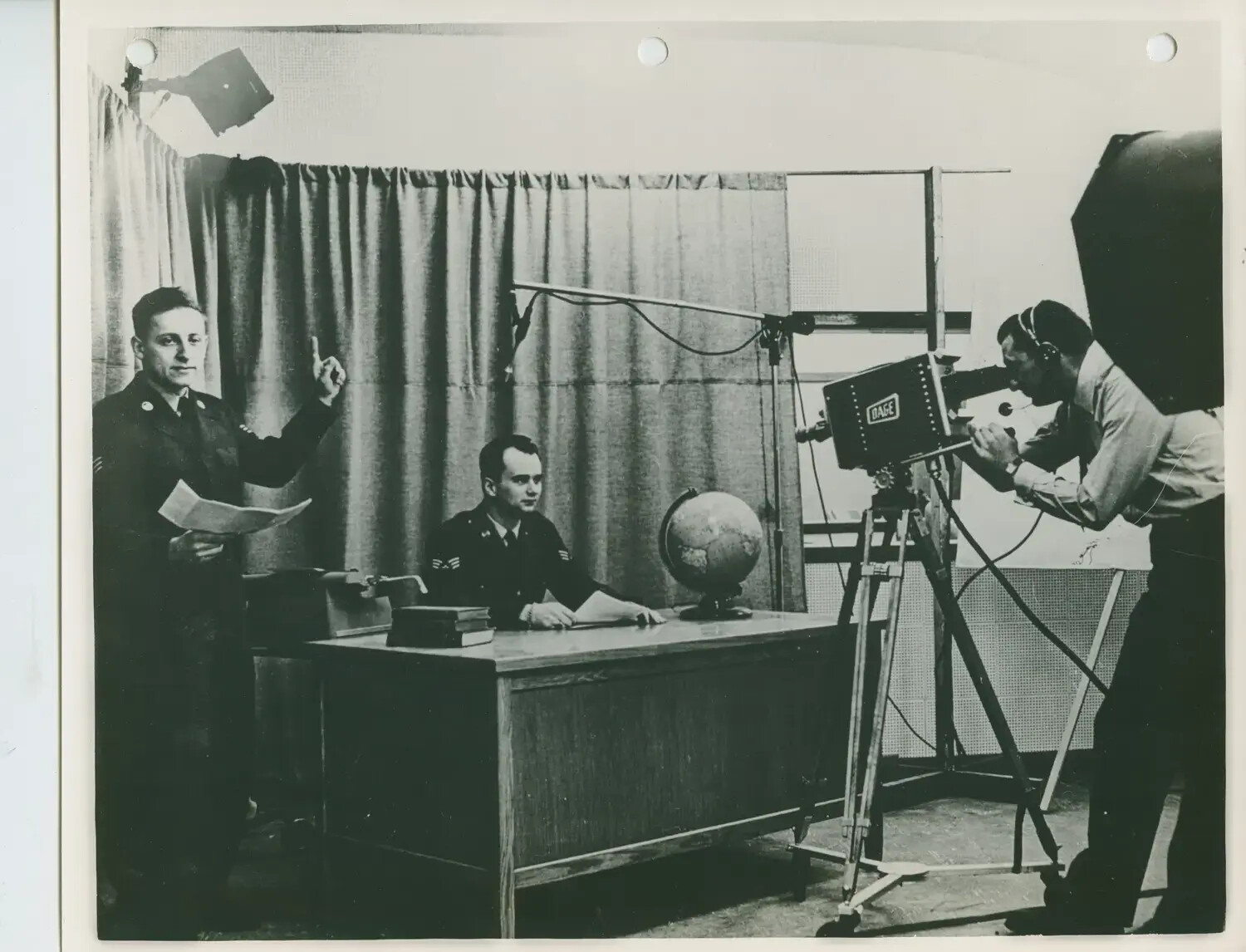 Armed Forces Radio and Television Service (AFRTS) Studio Production Scene, Serviceman at News Desk with Camera Crew