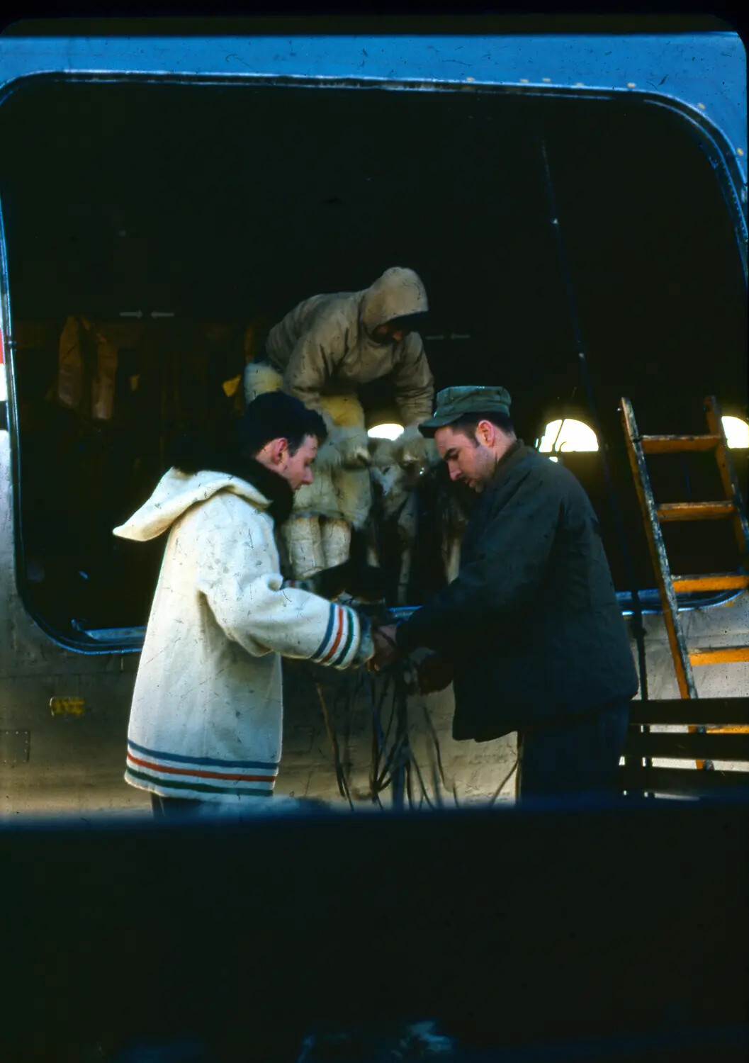 Airmen and Cold-Weather Clad Personnel Inspecting Aircraft Wiring, Thule Air Base, Greenland, c. 1950-1955