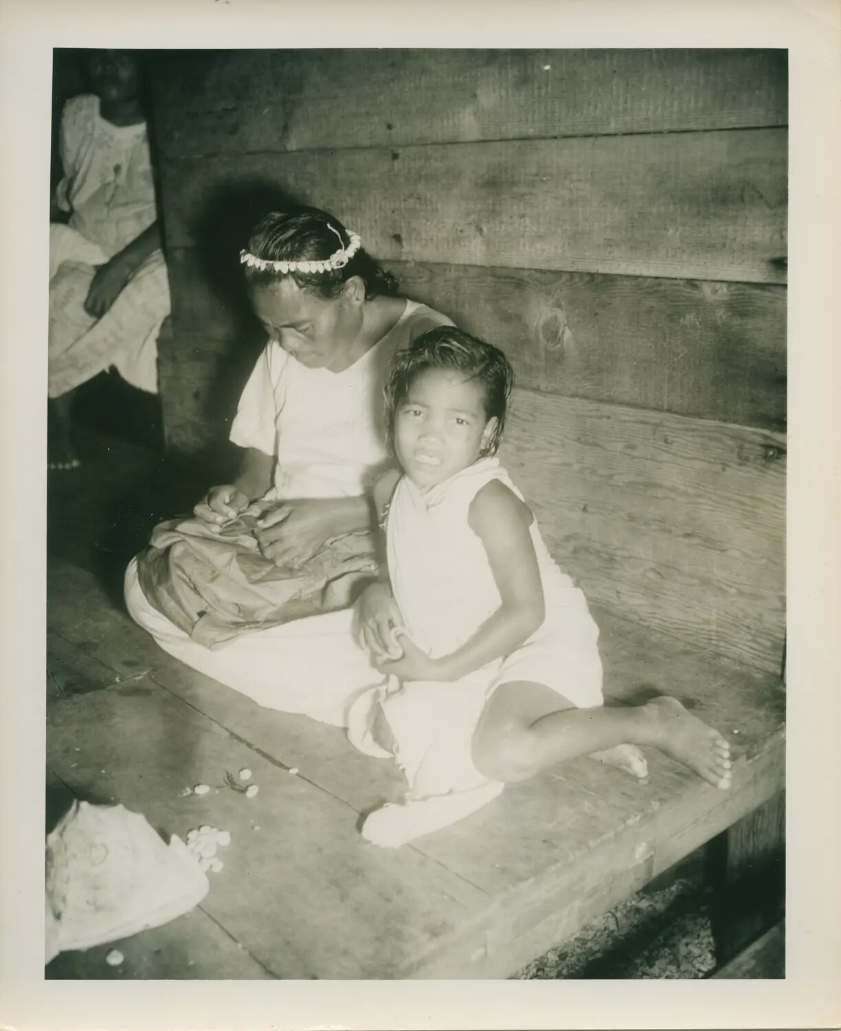 Pacific Islander Woman and Children on Wooden Porch, WWII Pacific Theater (USS Petrof Bay Collection)