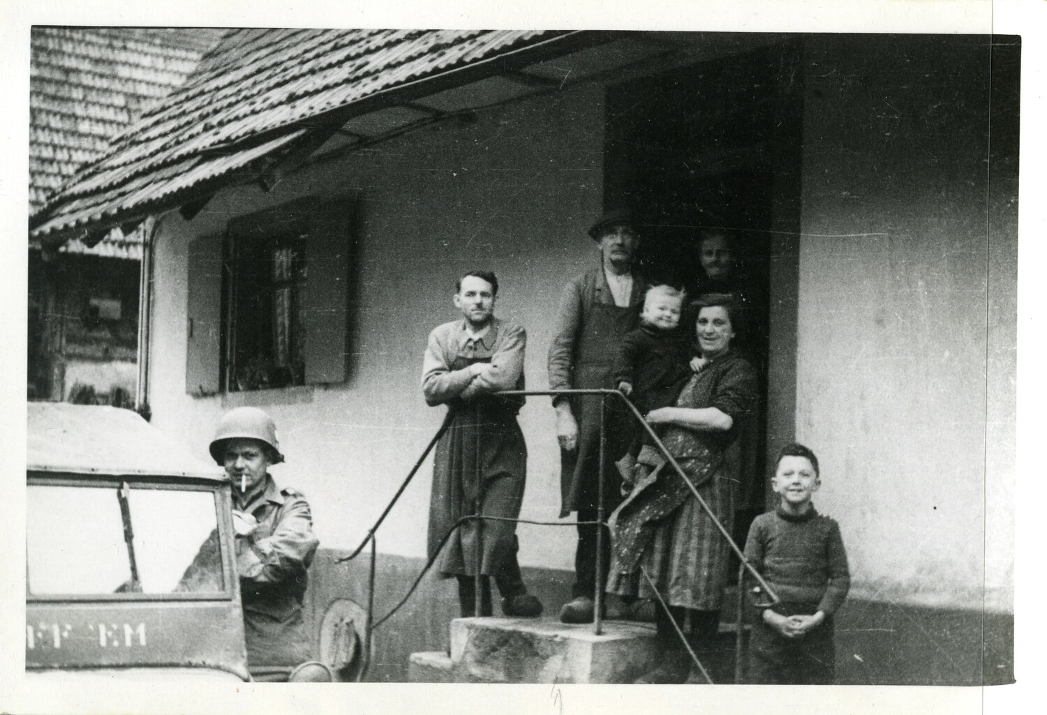 American Soldier and European Farm Family Outside Farmhouse, WWII Occupation/Advance Period