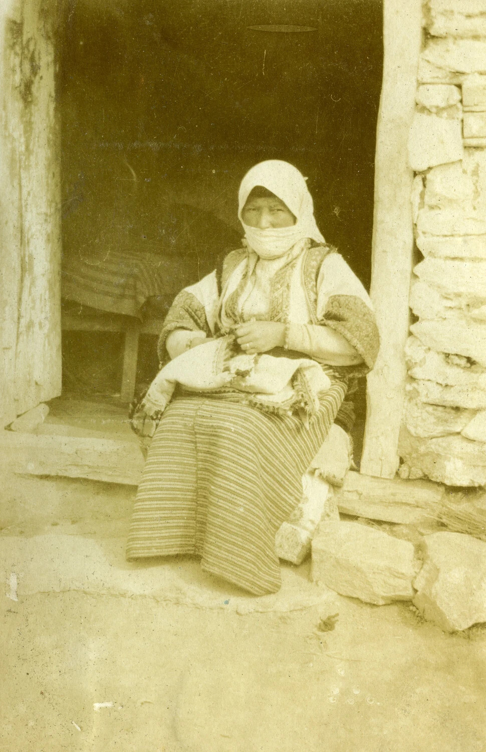 Portrait of a Local Woman in Traditional Dress, Seated in a Doorway — WWI French Pilot's Album
