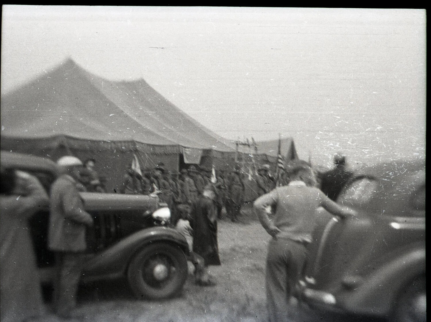 Encampment Scene with Tents, American Flag, and Parked Automobiles, State-Side, WWII Era