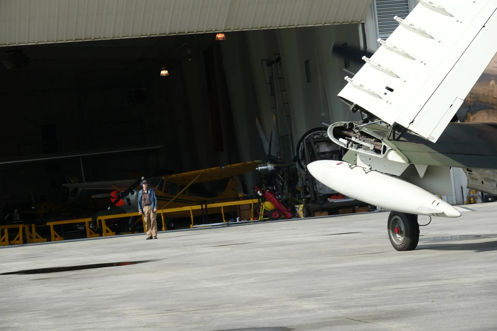 Folded Wing of A-1 Skyraider with Hangar Aircraft Beyond, May 2019 Event