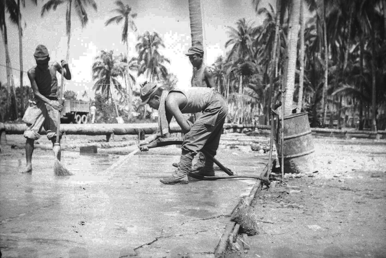 U.S. Servicemen Cleaning Pipeline on Concrete Apron, Luzon, Philippines, World War II