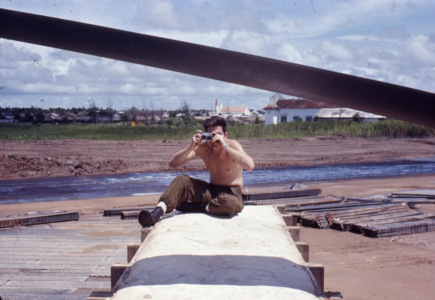 US Serviceman Photographing at an Engineer Construction Site, Vietnam War Era