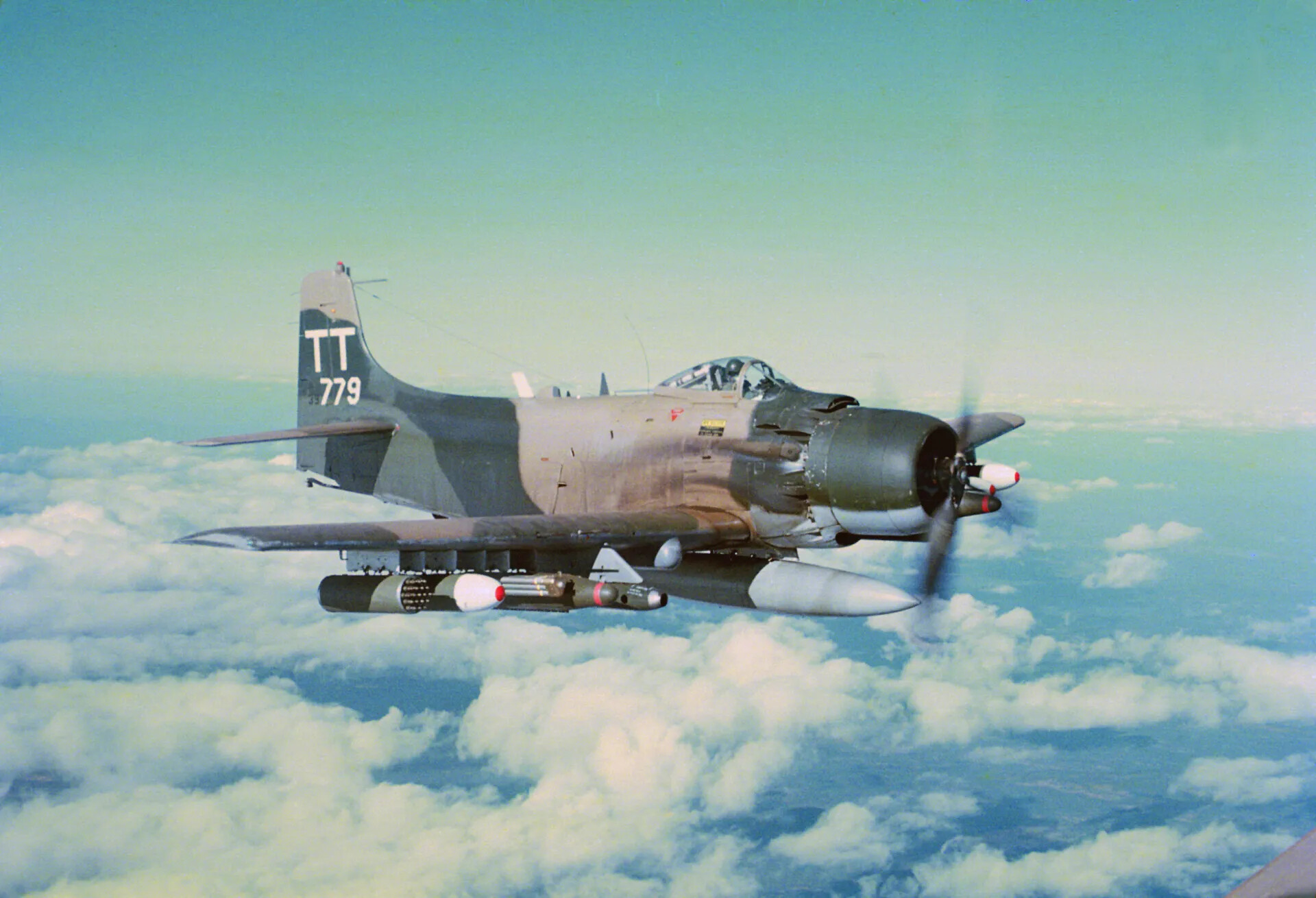 Douglas A-1 Skyraider "TT-779" in Level Flight Over Cloud Cover, Southeast Asia, circa January 1970