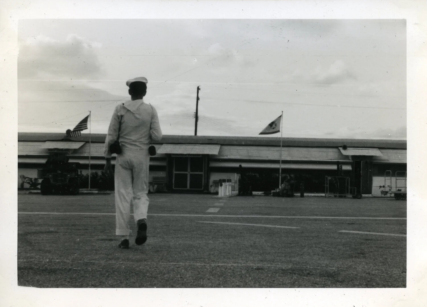 Sailor in Dress Whites Walking Toward Squadron Building, NAS Agana, Guam