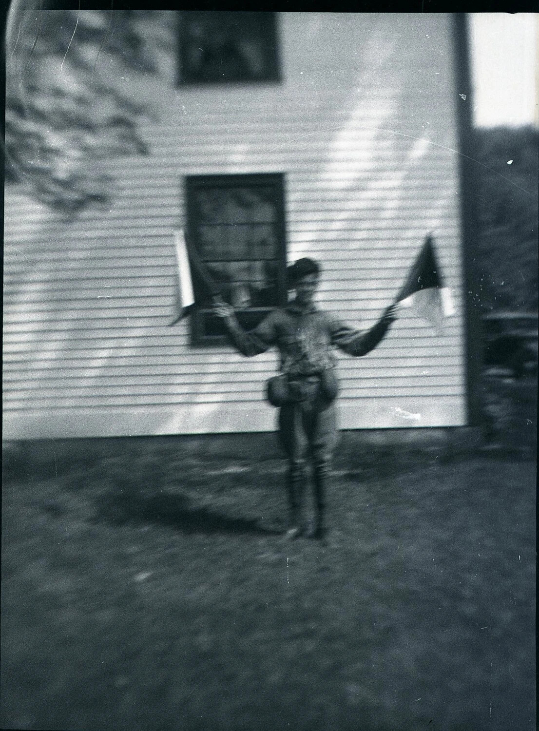 Youth Practicing Semaphore Flag Signaling, State-Side Residence, WWII Era